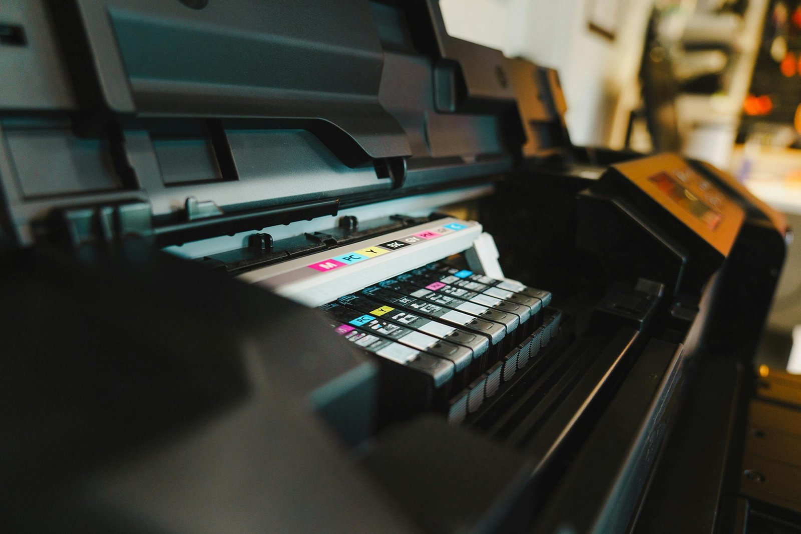 pexels-photo-17536002-17536002 Detailed view of ink cartridges inside a digital inkjet printer in an office setting.